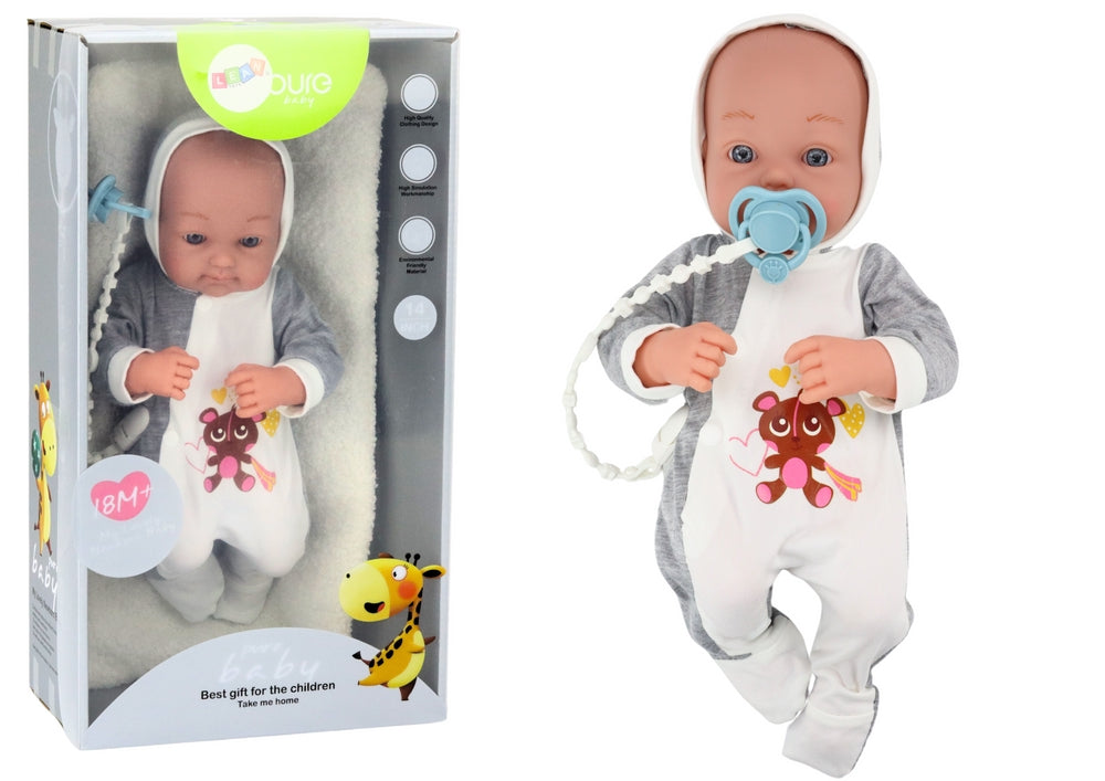 Babydocka 35 cm med rörliga armar/ben, napp på snöre och filt