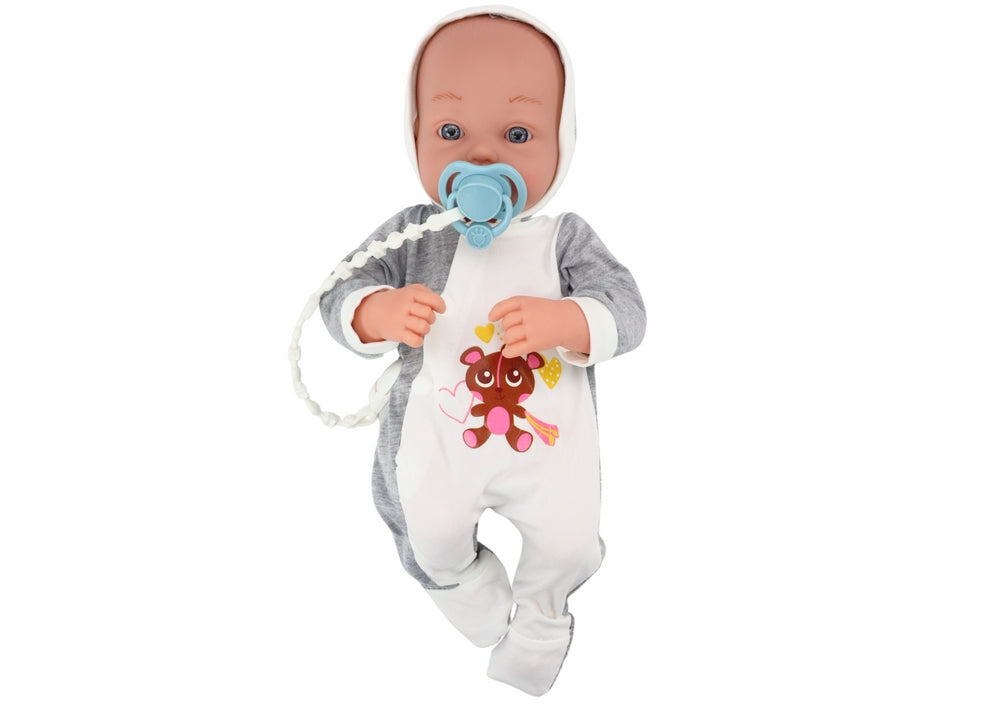 Babydocka 35 cm med rörliga armar/ben, napp på snöre och filt